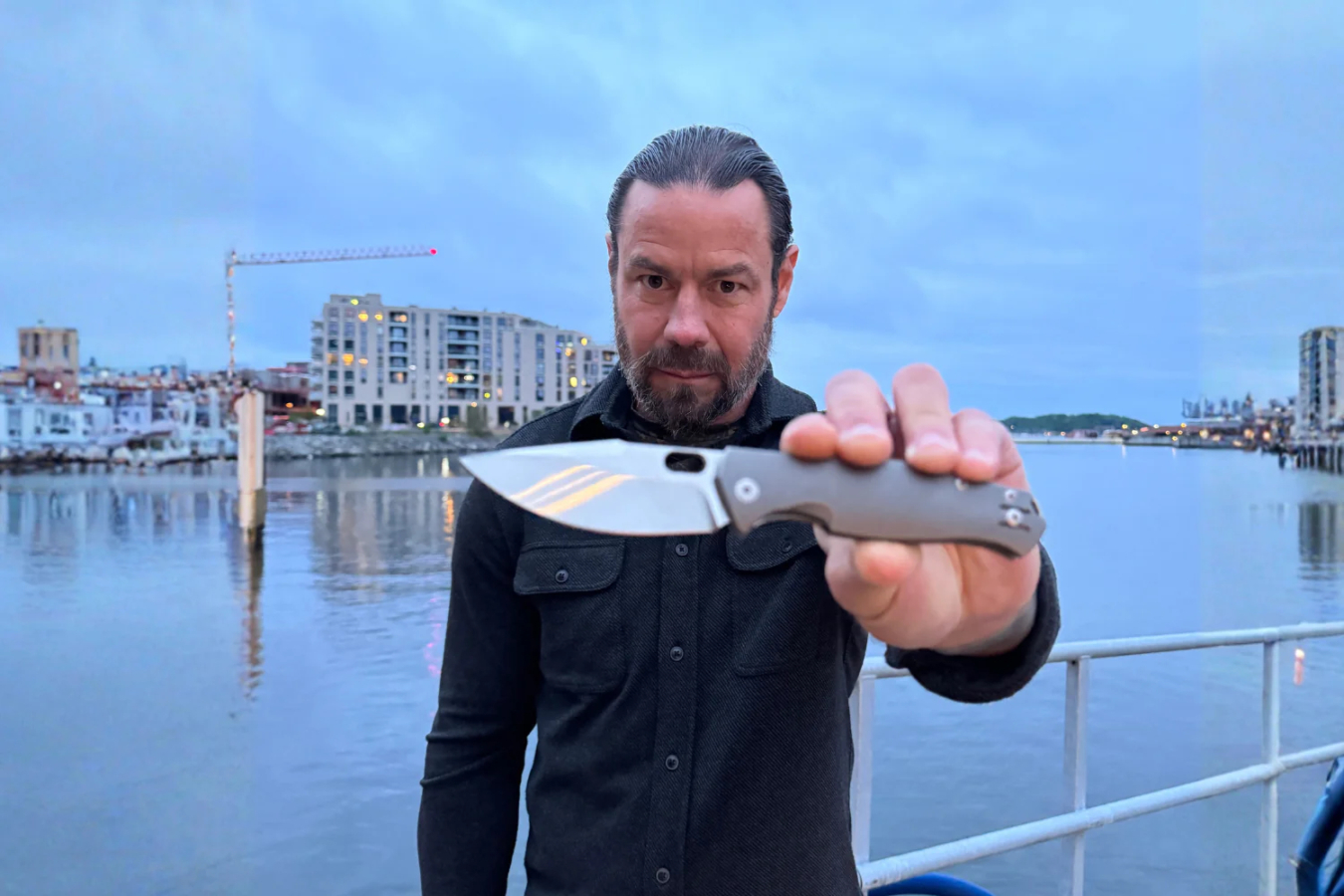 GiantMouse Pontius knife held toward the camera by the water