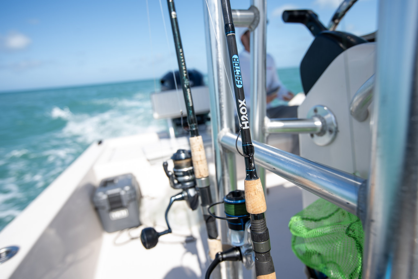 The Academy H20X Factor Spinning rod in a rod holder on a boat in the ocean.