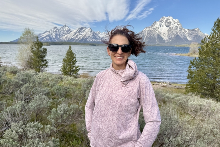 Woman on a hike wearing the Marmot AirExchange UPF 50 Hoody