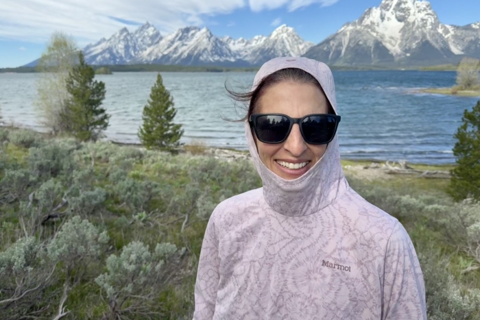 Woman on a hike wearing the Marmot AirExchange UPF 50 Hoody