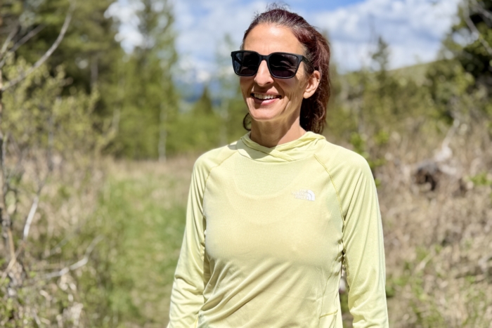 Woman on a hike wearing the TNF Sunriser hoodie