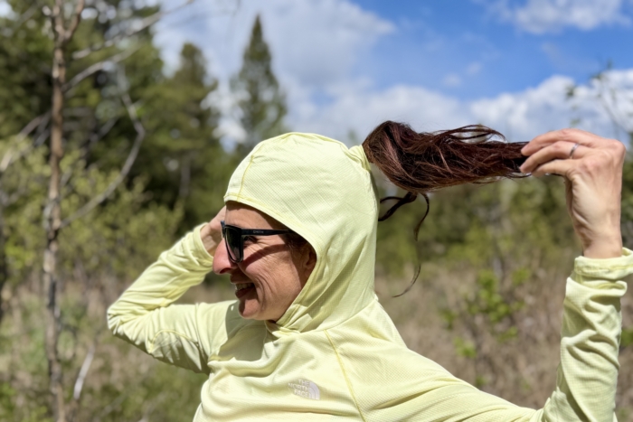Close up of a Woman wearing a sun shirt with a slit for a pony tail