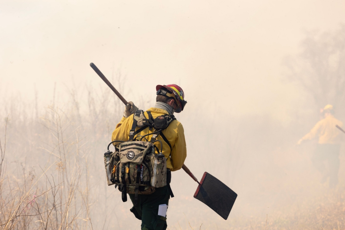 firefighter in smoke with shovel