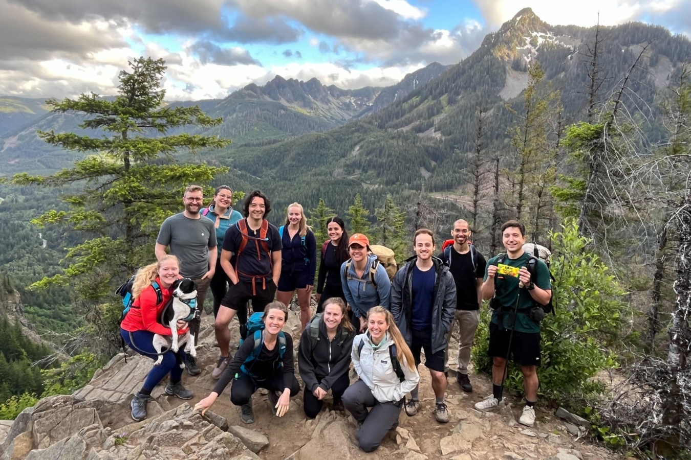 group of hikers stand together on mountain