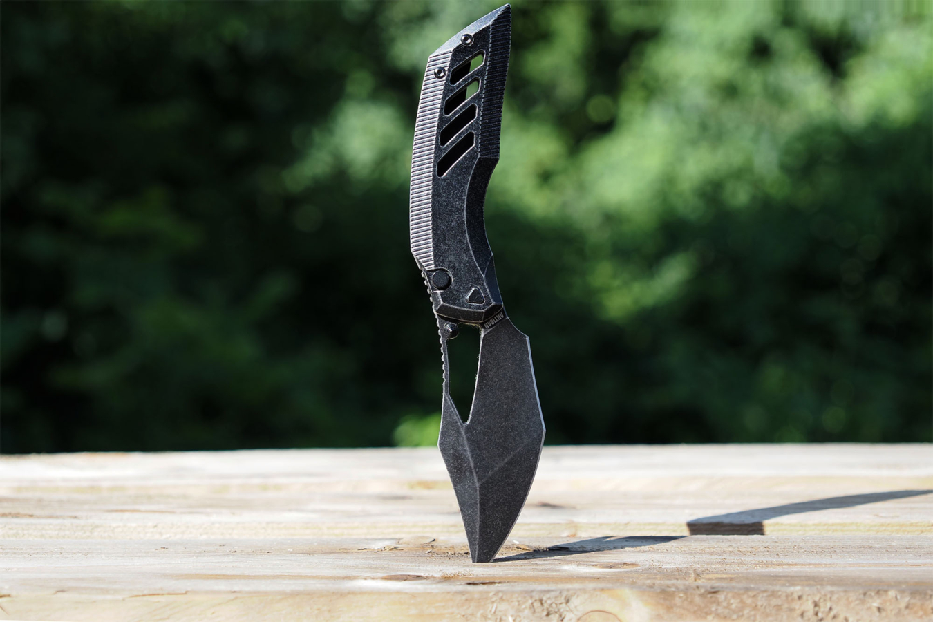 Artisan Cutlery Darkwing knife standing in wood