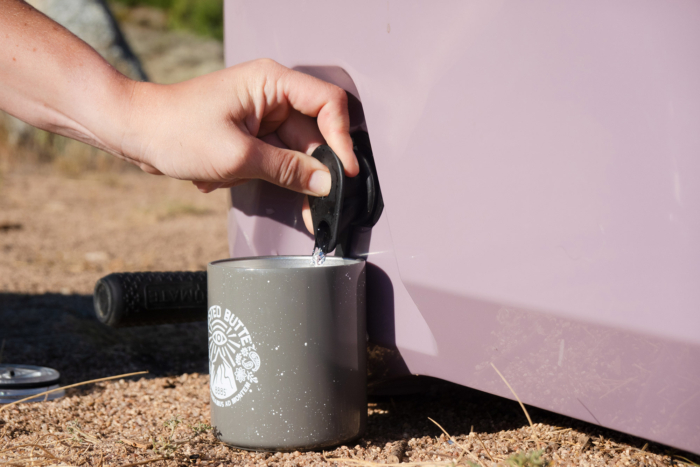 Close-up of water pouring from the rolling cooler dispenser