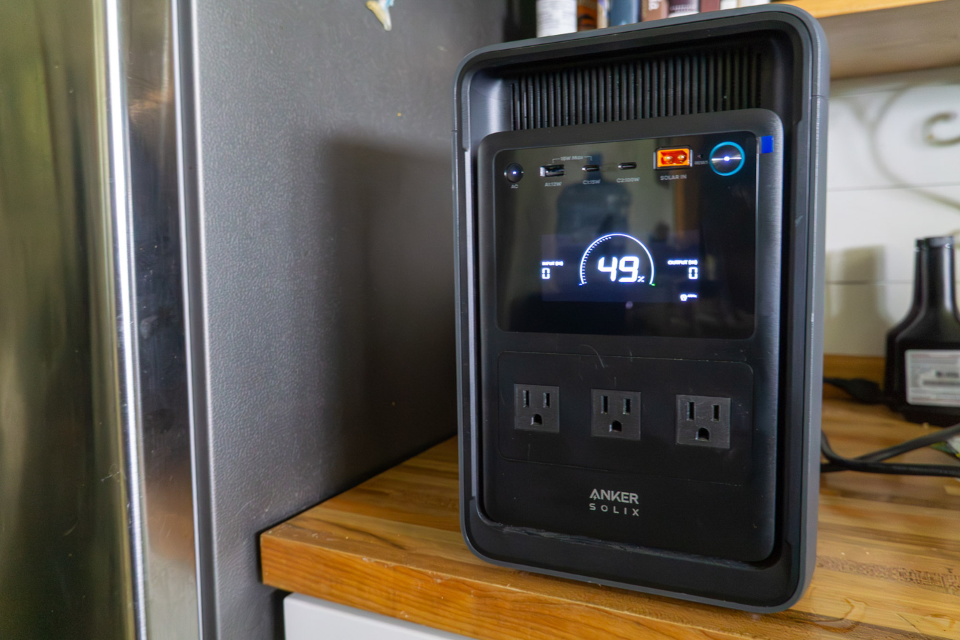 the anker solix s2000 power station on a kitchen counter powering a refrigerator
