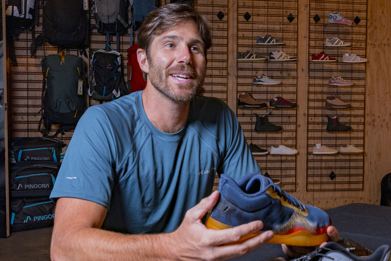 Adam Ruggiero learns about new shoes at the Outdoor Market Alliance trade show