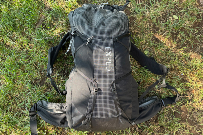 Black Exped Lightning 50 backpack lying on grass