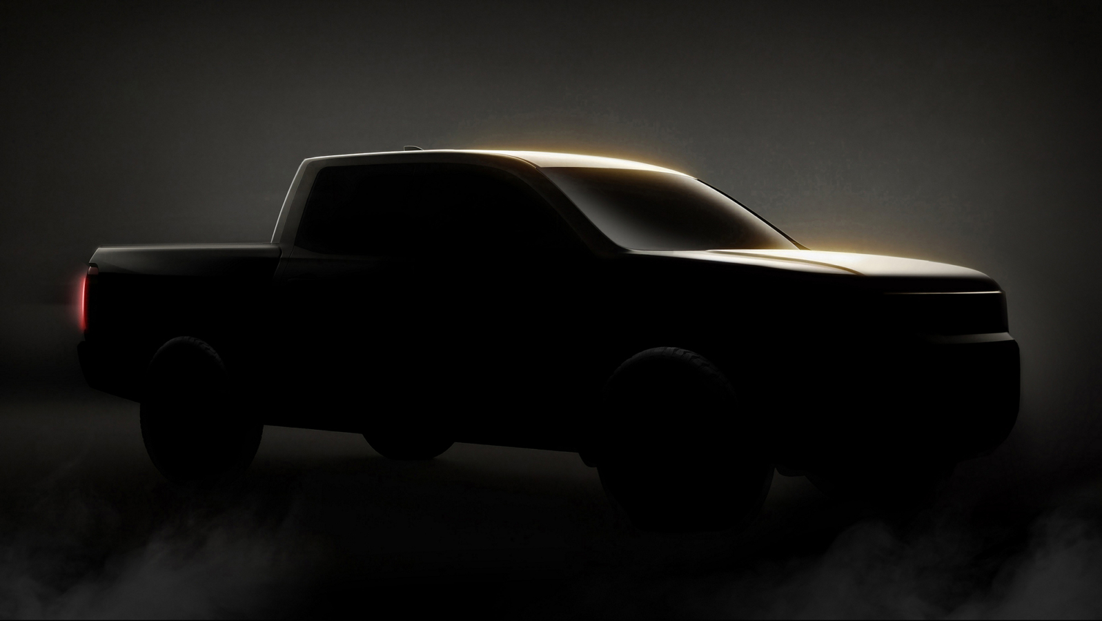 A shadowy outline of a truck against a black background.