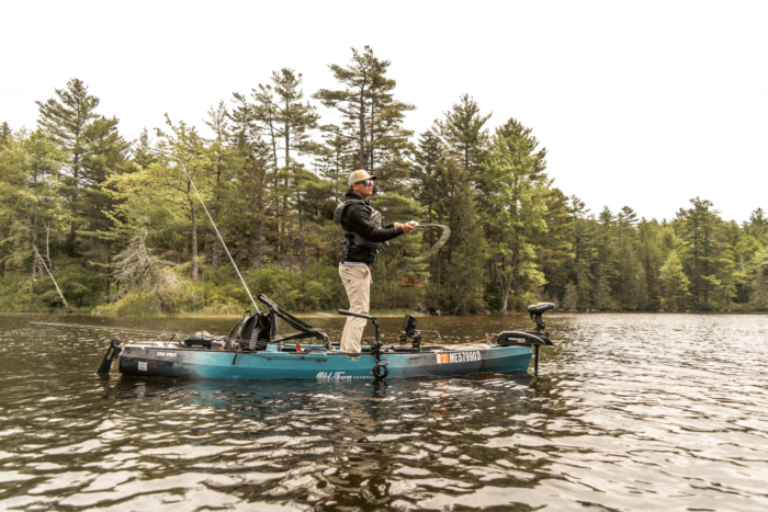 An angler casting from the Old Town Sportsman 120 Pro with a trolling motor and forward facing sonar unit attached to it.