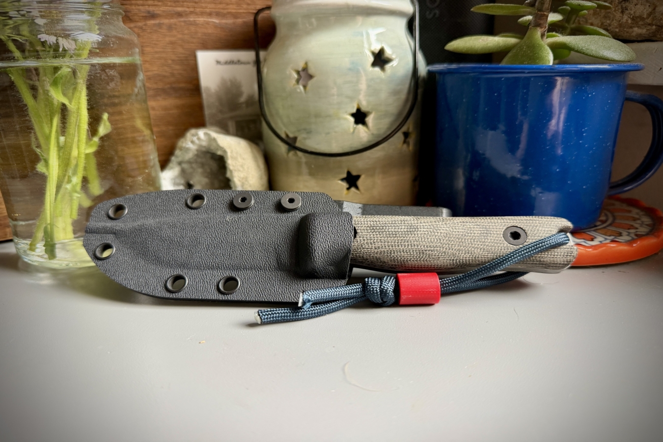 Reiff Knives F3 next to a blue cup