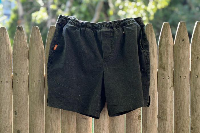 Front view of Ripton Trail Daemon shorts on a fence
