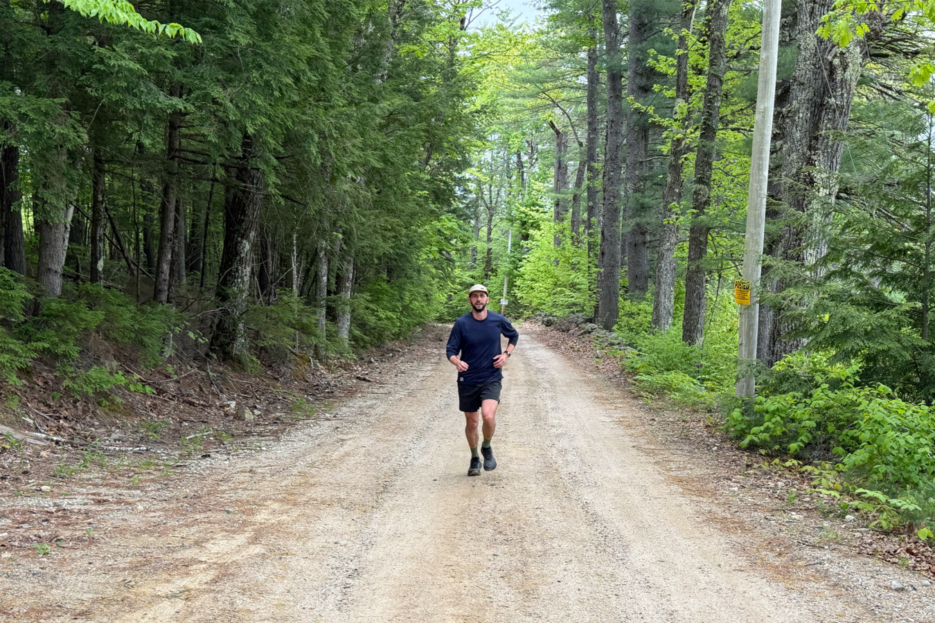 Runner testing Ripton shorts on a forest road