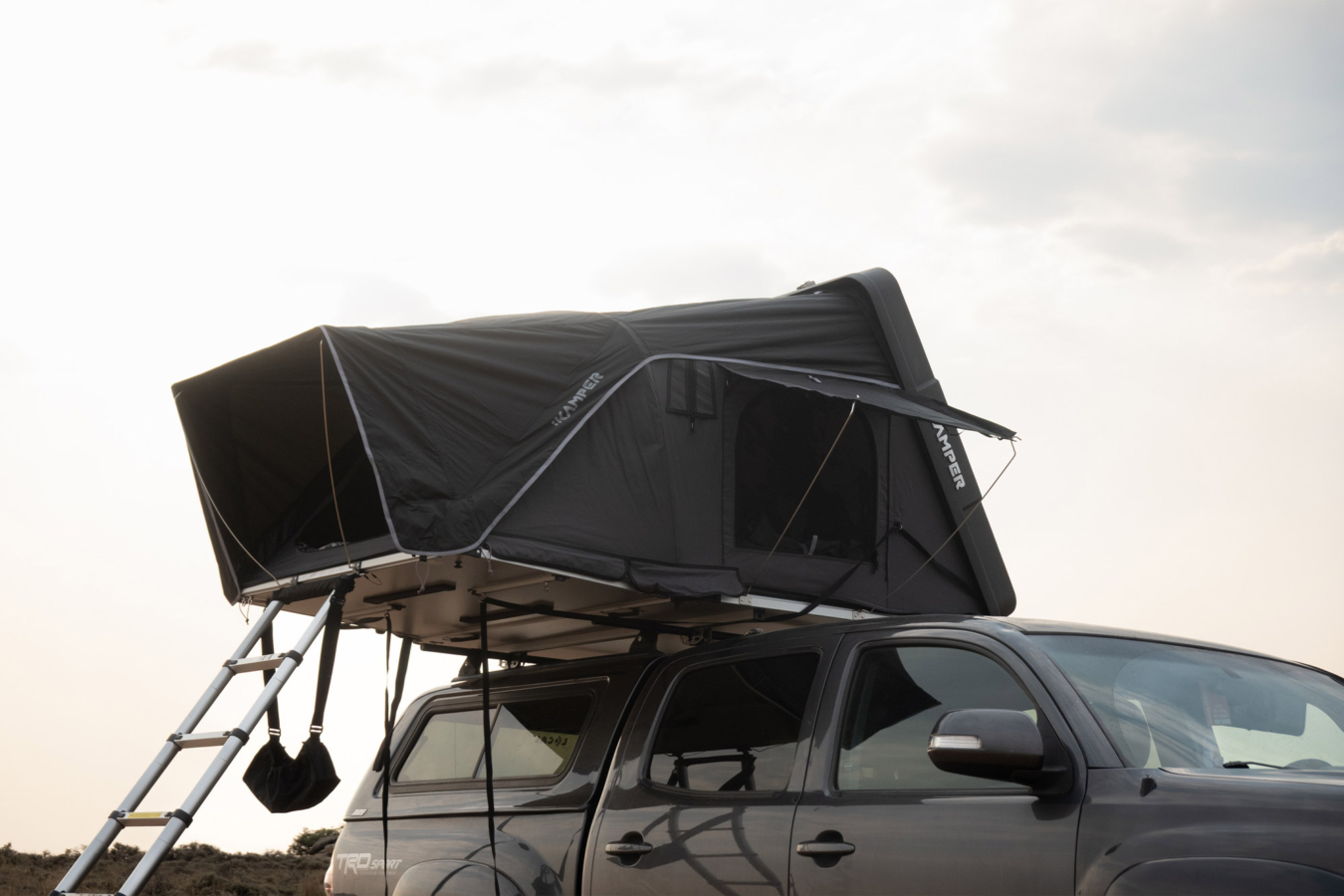 Open iKamper camper with ladder mounted on a pickup truck