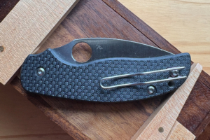 Spyderco Sage 6 knife with wire pocket clip on a wooden surface