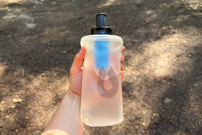 person holds soft water flask