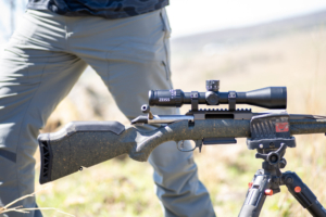 The ZEISS V3 Riflescope on a rifle that's resting on a tripod.