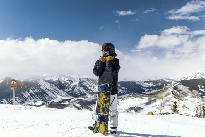 snowboard holding nose of snowboard upright