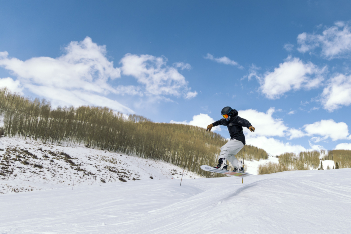 snowboarder doing a 180 on roller with Merc