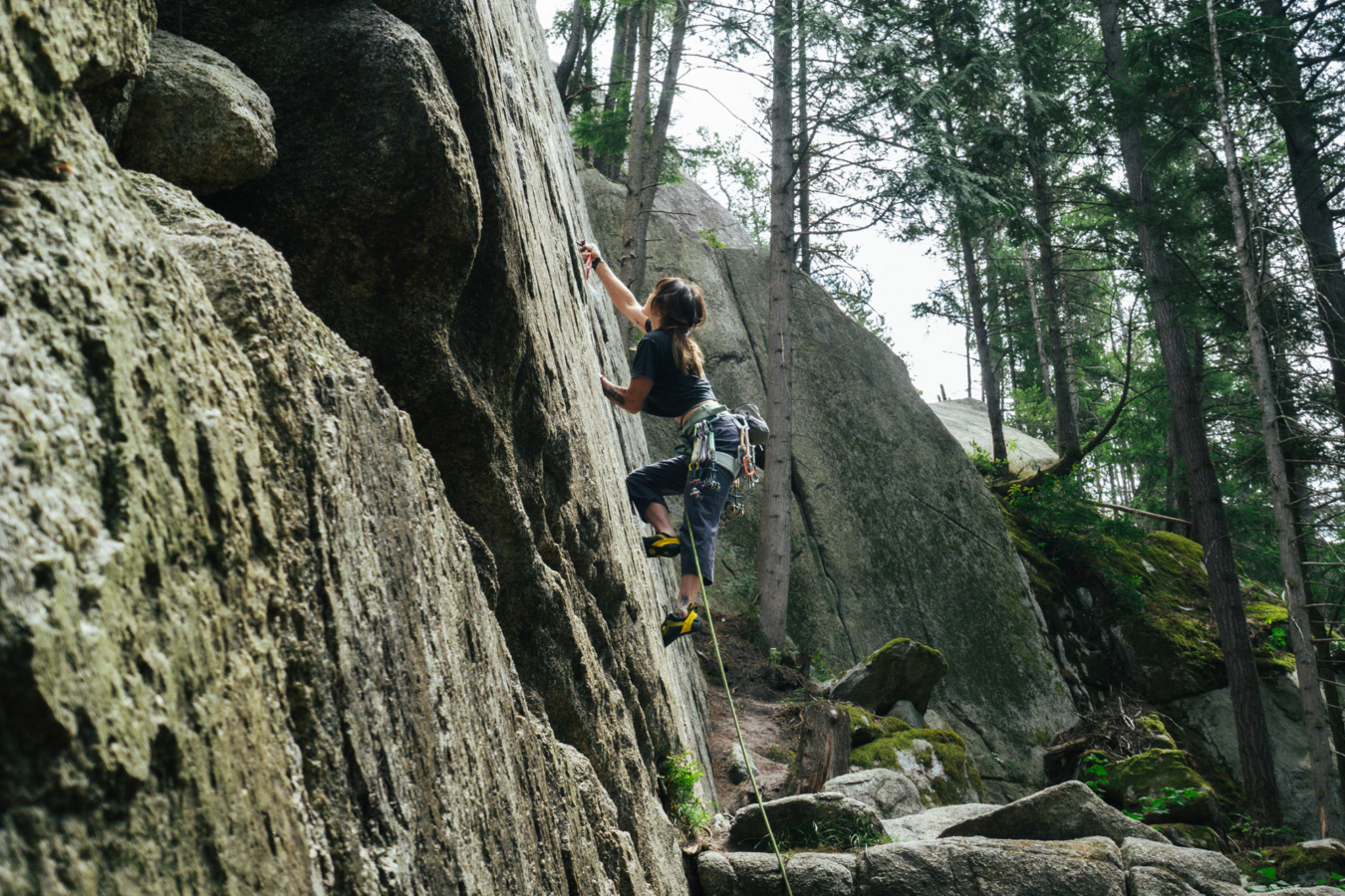 Climber wearing a Black Diamond Momentum harness on an outdoor rock route