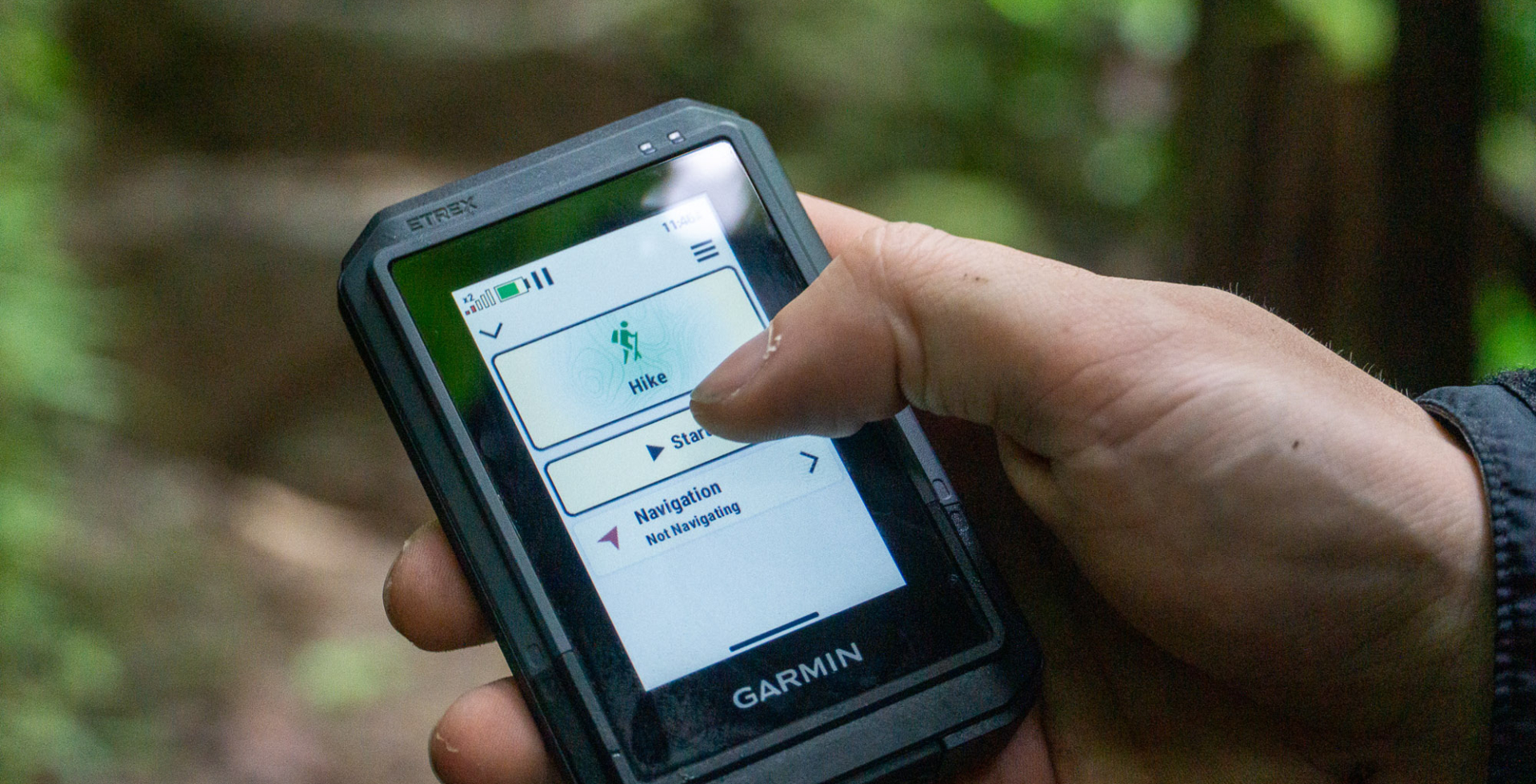 a hiker holds the garmin etrex touch