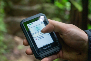 a hiker holds the garmin etrex touch