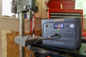 the jackery homepower 1000 v2 on a workbench powering a drill press