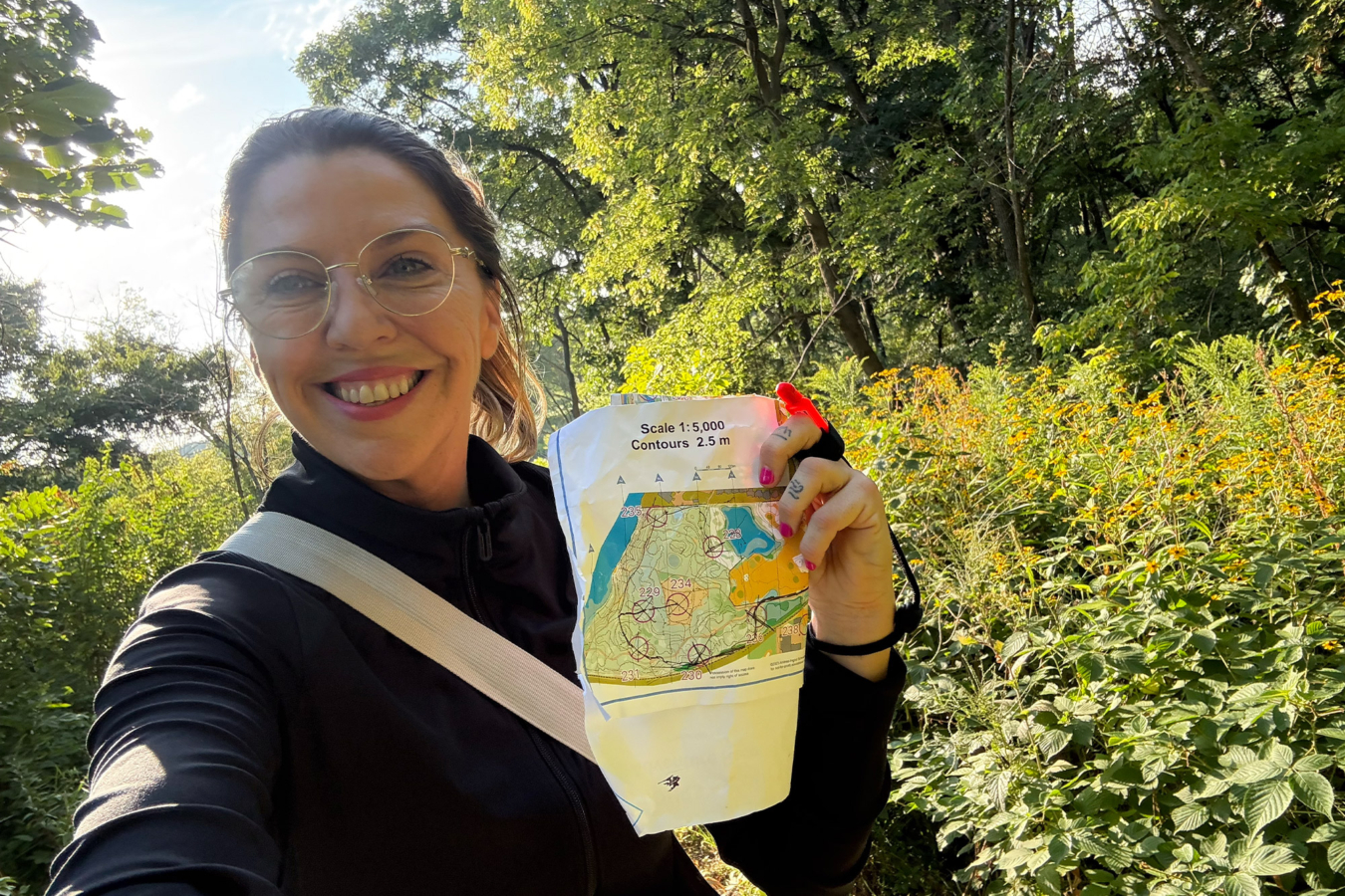 Runner holding a map during her first orienteering race