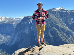 the author stands at an overlook in yosemite national park wearing the overshirt
