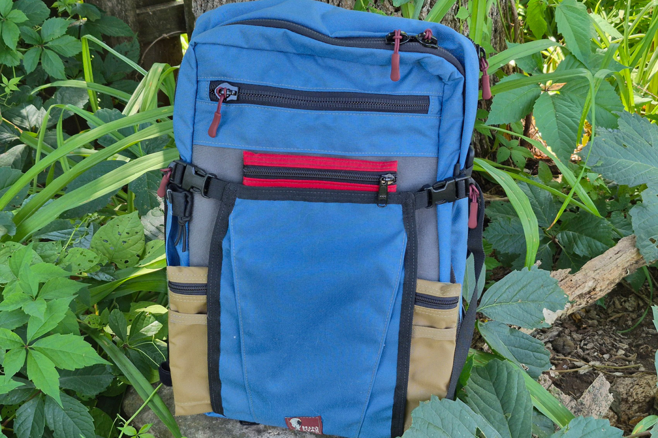 Blue Commuter pack with multiple front pockets and compression straps