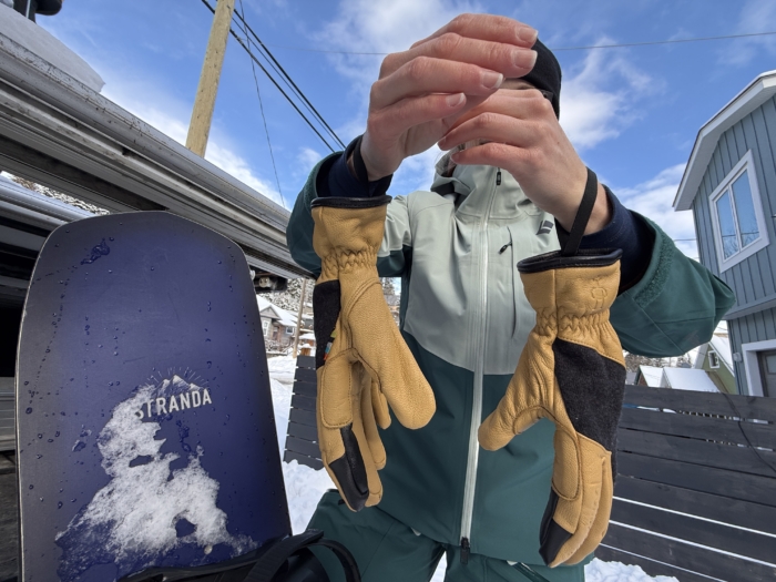 person holding up Smartwool Ridgeway Glove hanging around wrist
