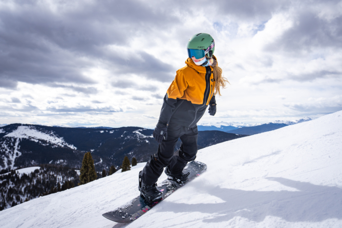 snowboarder riding down hill