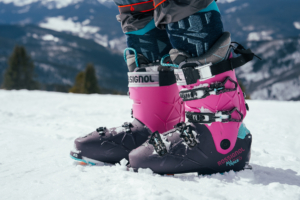 side profile of ski boot with mountain backdrop