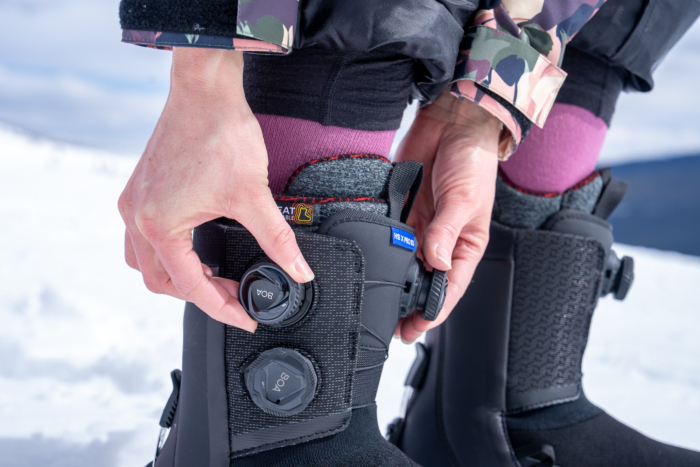 hand on BOA dial for snowboard boot