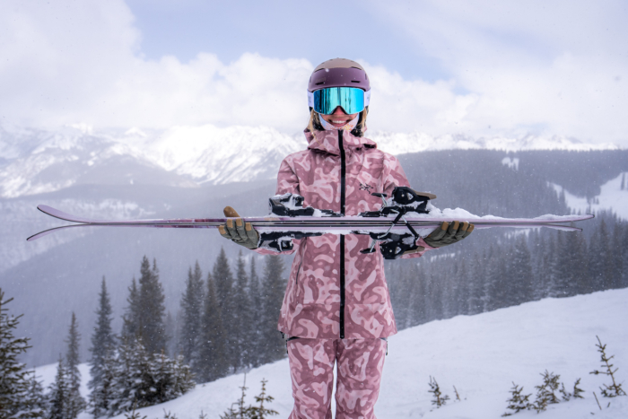 skier holding skis with profile sideways