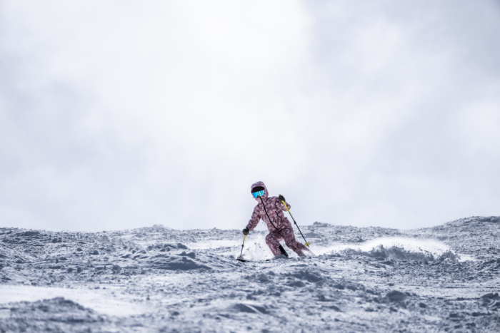 skier descending powdery moguls