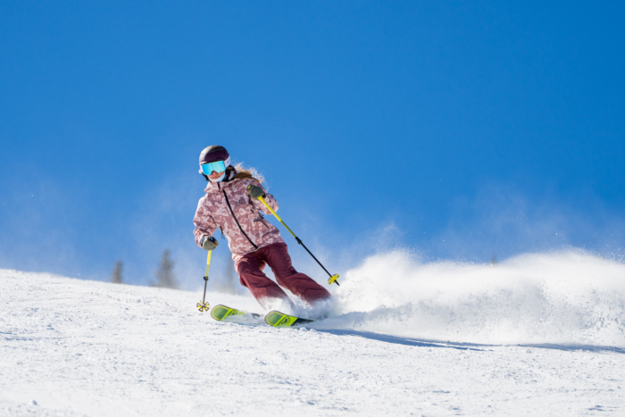 downhill skier slashing snow