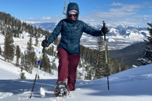 Snowshoer wearing MSR Revo Explore snowshoes on a mountain trail