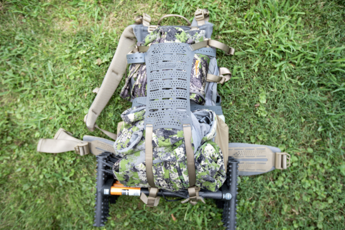 A hunting backpack with layers strapped to the outside.
