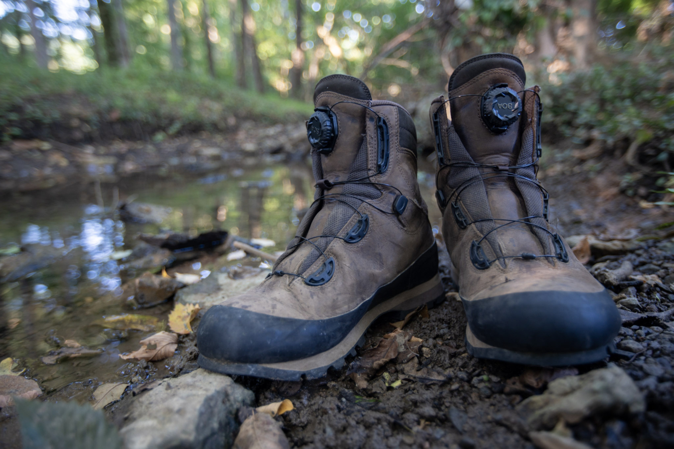 The Meindl Boa Speed Hunter boots next to a creek.