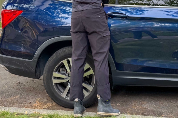 Image of pants rolled up at the hem while loading car