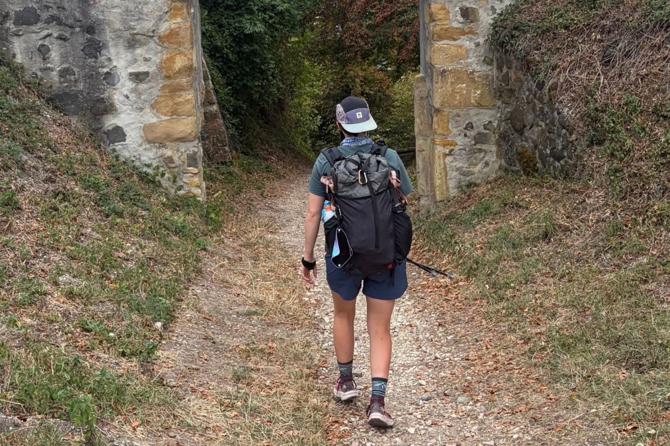 rear view of person walking down hill