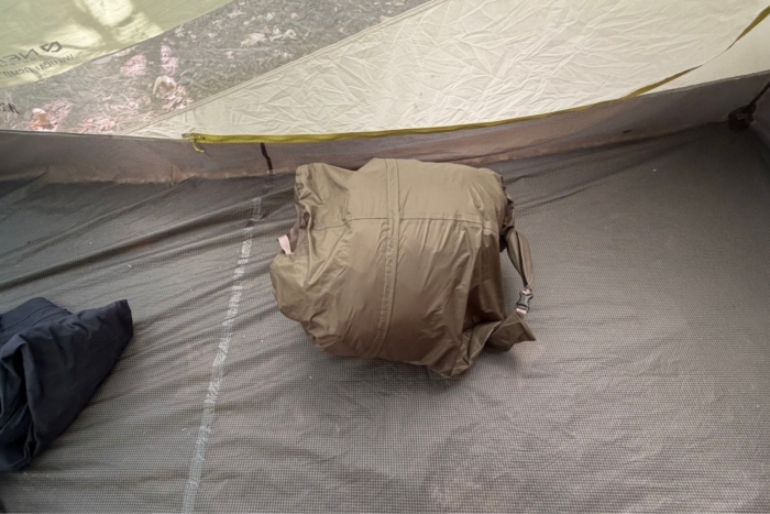 sleeping pad packed up on floor of tent