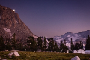 canvas tents near mountain at sunset