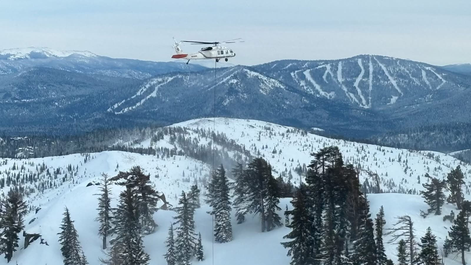 Helicopter over snowy mountains