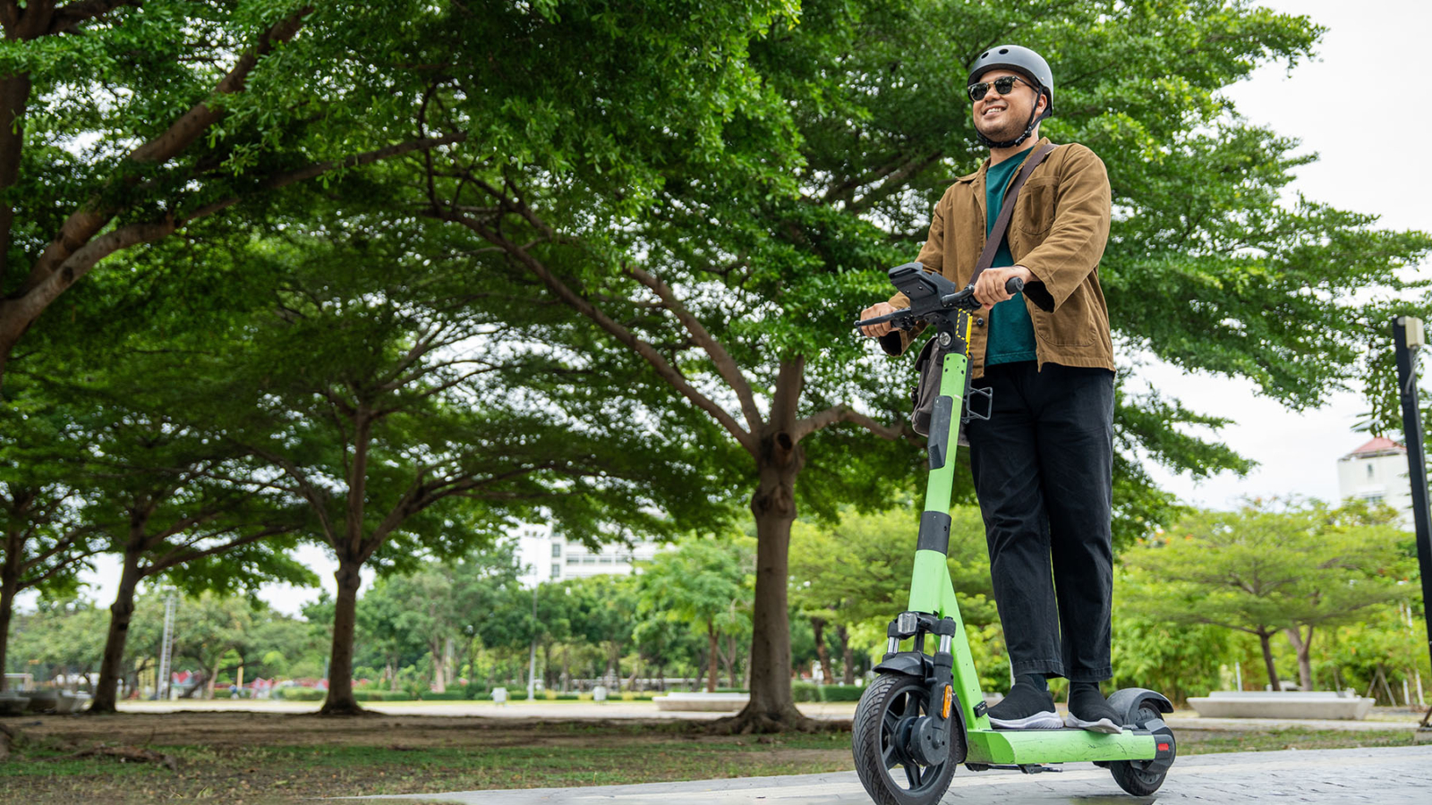 Young,Asian,Man,Ride,Scooter,Ev,Eco,Friendly,Transport.,Sustainable