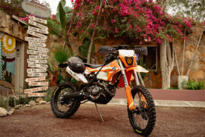 KTM 500 Baja motorcycle build parked outside a restaurant in Mexico
