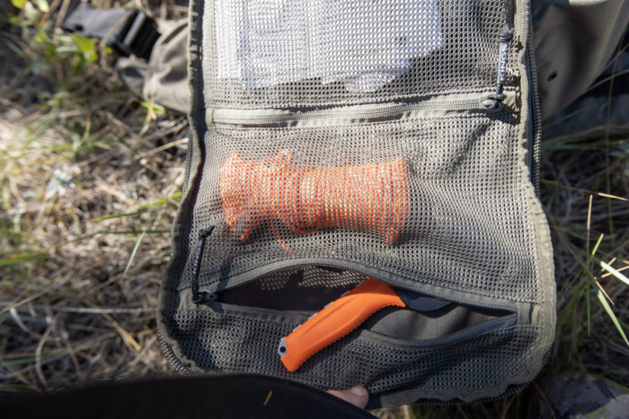 Rope and a hunting knife in the organization pockets of a hunting backpack.