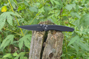 Pro Tech Avalon knife open on a weathered stump